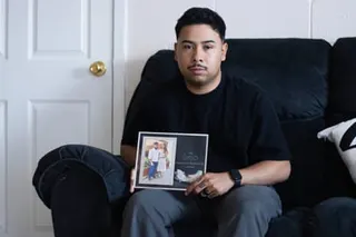 a man holds a picture of his wife