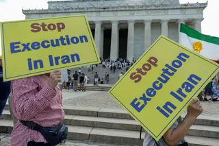 People hold banners reading "Stop execution in Iran".
