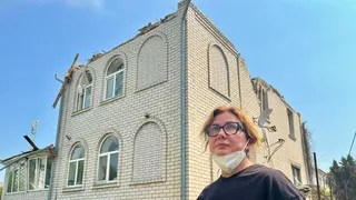 A woman and her destroyed home
