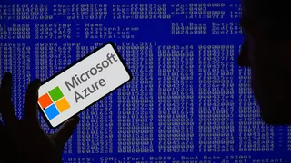 Microsoft Azure is being displayed on a smartphone with a Windows blue screen visible in the background