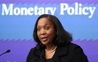 a woman speaks into a microphone