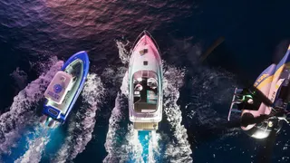 Official GTA 6 image showing a boat racing away from a police boat and helicopter, from above towards the top of the screen
