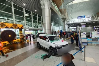 A woman was injured after the SUV she was driving crashed through the glass entrance of the departure hall at Kota Kinabalu International Airport today. — Social media pic via The Borneo Post