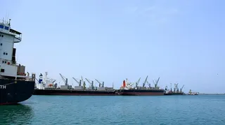 Ships unload their cargo at the port of Yemen's Huthi-held city of Hodeida on July 28, 2024