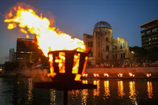 People gather along the Motoyasu River as ceremonial bonfires are lit before the Atomic Bomb Dome in Hiroshima on August 5, 2026, ahead of the 81st anniversary of the world’s first atomic bomb attack. — JIJI Press/Japan OUT/ AFP pic