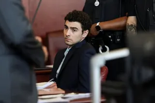 a man in a suit sits in court