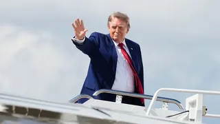 President Donald Trump boards Air Force One on Friday en route to a weekend at his golf club in Bedminster, New Jersey.