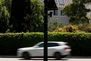 A car drives by a Flock Safety camera mounted to a light pole in Beverly Hills, California. Photo: Getty Images via AFP