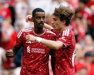 Lewis Koumas (right) congratulates Alexander Isak after he opened the scoring at Anfield