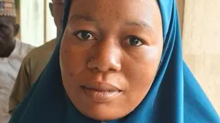 One of the Nigeria mass wedding brides Amina Alhassan wearing a blue Hijab