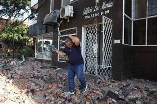 A man leaves a block of flats after an earthquake struck Cali, Colombia, on Monday. Photo: AP