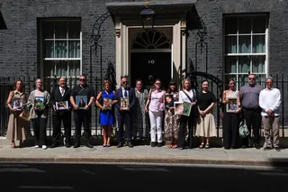 LONDON, ENGLAND - MAY 26: Bereaved parents pose with images of their children outside Downing Street on May 26, 2026 in London, England. Keir Starmer is holding a round table with bereaved parents to discuss how tech giants should provide safe products, and how just a ban on social media for the under-16s would let the companies "off the hook". (Photo by Carl Court/Getty Images)
