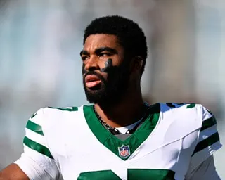 Jets cornerback Qwan'Tez Stiggers looks off to the side while warming up in uniform