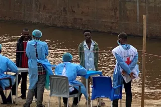 Passengers from an intercepted boat wait to be tested in Kinshasa, Democratic Republic of the Congo