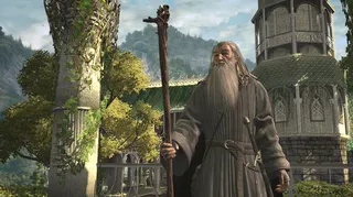 An old white man with a long grey beard and long grey hair, and a long grey robe - grey is evidently a favourite colour of his - stands in front of an ornate architectural stone building that has lots of plants growing on it. This man in Gandalf, and he's a wizard, and he's standing in front of the elven city of Rivendell, I believe.