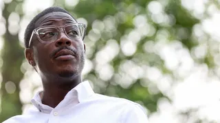 David Crowley, wearing glasses and a white shirt, stands outdoors in Milwaukee.