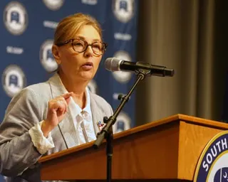 A woman speaks into a microphone