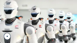 A row of humanoid robots are on display after rolling off the production line at a production facility in China