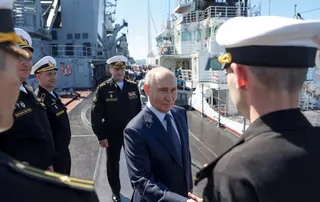 Russian President Putin shakes hands with officers on board the Russian Navy’s guided missile cruiser Varyag during the final stage of the Pacific Fleet’s naval drills on far eastern Sakhalin Island on Thursday. Photo: AFP