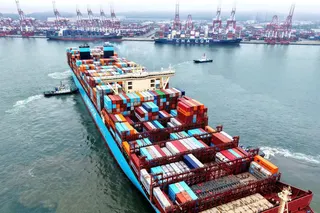 A container ship is moved into position at the port in Qingdao, in China’s eastern Shandong province, on May 26. Photo: AFP