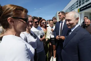 Russia’s President Vladimir Putin interacts with local residents on Iturup island, one of four islands in the contested chain known as the Kuril Islands on August 13, 2026. Photo: Sputnik/AFP