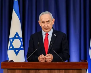 The Israeli prime minister, Benjamin Netanyahu, speaks during a press conference in Jerusalem, at a lectern with the Israeli flag behind him