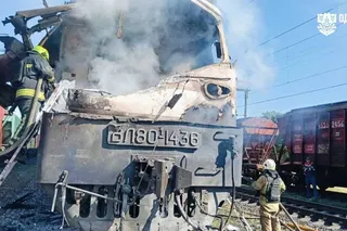 Firefighters extinguish a fire on a train.