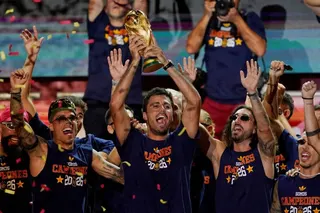 Spain's Rodri celebrates with the World Cup trophy and teammates on stage at Cibeles Square in Madrid after the victory parade as fans gather to celebrate winning the World Cup