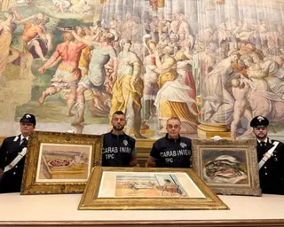 Four Carabinieri officers display the framed paintings by Cézanne, Renoir and Matisse