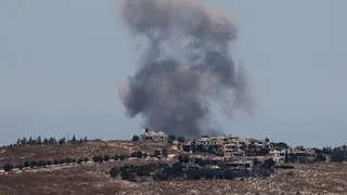 Smoke rises above houses following an Israeli strike near Nabatieh al-Fawqa last month.