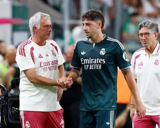 The Real Madrid manager José Mourinho (left) shakes hands with his team's midfielder Federico Valverde (right) during a pre-season friendly against Ferencvaros in Budapest.