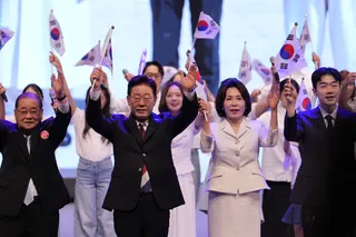 South Korean President Lee Jae Myung and his wife Kim Hea-kyung waves the national flags during a ceremony to celebrate the 81st anniversary of the Korean Liberation Day in Seoul on Saturday. Photo: EPA