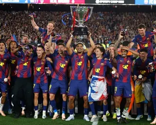 Barcelona’s squad lift the La Liga trophy after winning the league.