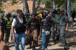 Moroccan security forces arresting migrants trying to enter the north African Spanish enclave of Ceuta on Aug 15.
