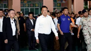 Thai Prime Minister Anutin Charnvirakul, wearing a white, visits the school