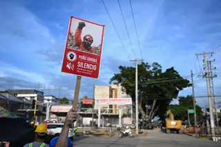 A rescuer holds a sign reading “Silence, I am listening” near collapsed buildings in Cali, Colombia, on August 14, 2026, as the government seeks US tariff relief to help businesses recover from the deadly earthquake. — AFP pic