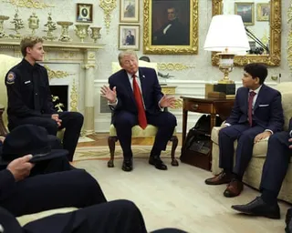 Trump gestures while speaking with lifeguard Ryder Williams in the Oval Office