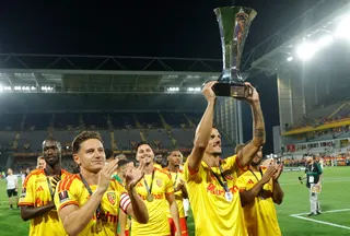 Lens' French forward Florian Sotoca holds the championship trophy as he celebrates with his teammates after winning the French Super Cup (Trophee des Champions) football match against Paris Saint-Germain (PSG) at the Stade Bollaert-Delelis stadium yesterday. — AFP pic
