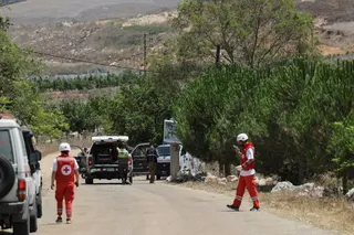 Paramedics and Lebanese soldiers stand in the outskirts of the southern village of Zawtar al-Gharbiyeh, Lebanon, July 23, 2026. REUTERS/Emilie Madi