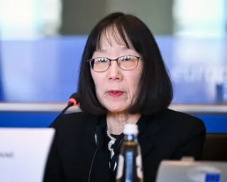 a woman speaks into a microphone
