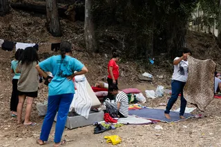 Moroccan women migrants arrange blankets and belongings at a makeshift sleeping area near the Temporary Immigrant Reception Centre in Ceuta, Spain, on Sunday. Photo: Reuters