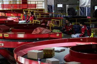 Parcels move along conveyor belts at e-commerce giant JD.com's sorting centre in Beijing. Photo: Reuters