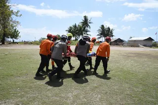 This handout picture taken and released on August 19, 2026 by Indonesia's Search and Rescue Agency (BASARNAS) shows rescue personnel evacuating a person on a stretcher in East Manggarai, following a 7.7-magnitude earthquake that struck Indonesia's Flores island on August 15. The number of people displaced and injured by a powerful earthquake three days ago has jumped significantly, emergency officials said on August 18, with at least 40,000 people living in temporary shelters. — Indonesia Search