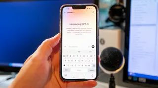 A person holds an iPhone with the ChatGPT app open