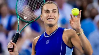 Aryna Sabalenka holds up a ball and her tennis racquet after beating Wang Xinyu at the Cincinnati Open