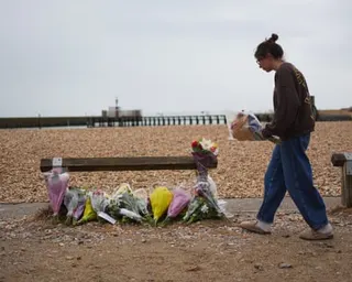 A person lays a flowers on the beach at Shoreham-by-Sea, West Sussex.