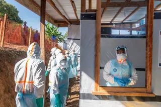Health workers stand in a new Ebola treatment center during a visit of Tedros Adhanom Ghebreyesus, Director-General of the World Health Organization (WHO), in Bunia, in the northeastern Democratic Republic of the Congo. [May 31: AFP]