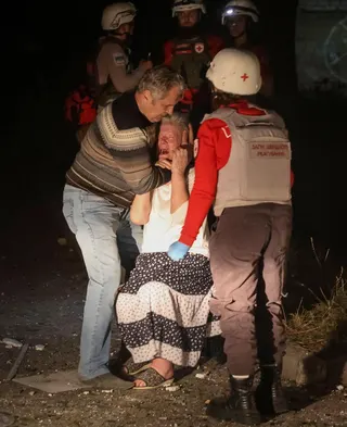 A woman crying near the body of her grandson in Kyiv, after he was killed in a Russian missile strike on an apartment block on Aug 20.