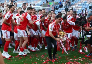 Arsenal Manager Mikel Arteta with the trophy as he celebrates with players after winning the Premier League last season