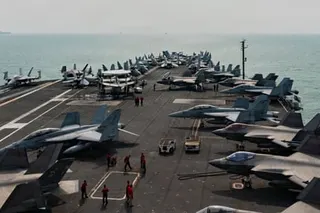 fighter jets on an aircraft carrier